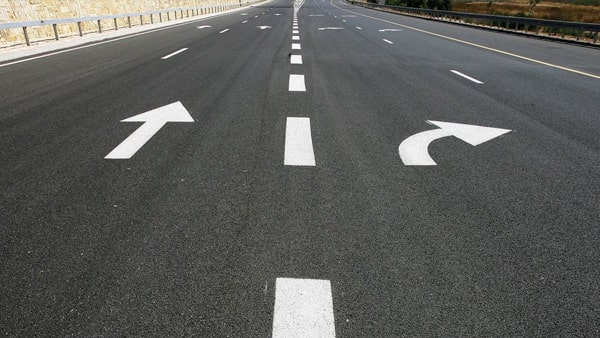 A broken white center line on the roadway means:
