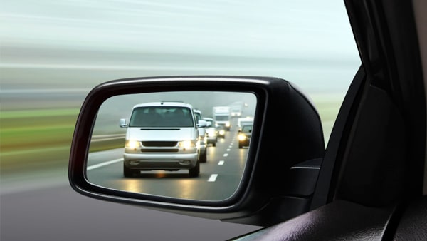 The car behind you begins to pass you. You should: