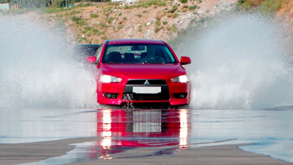 If the roadway is wet and your car starts to skid, you should: