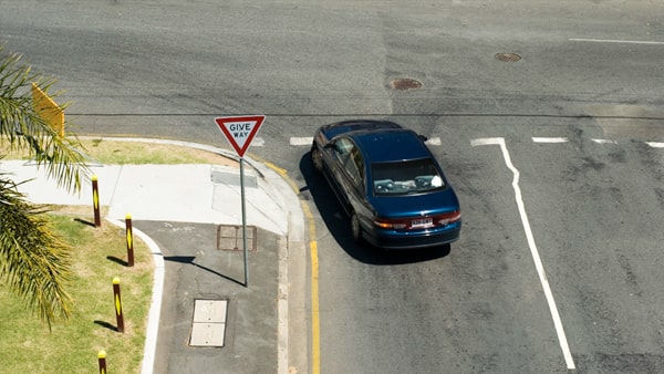 You are waiting in the intersection to complete a left turn. You should: