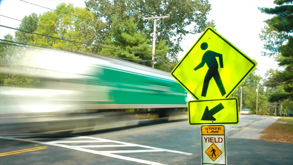 If a pedestrian is in a crosswalk in the middle of a block: