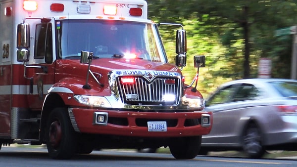 When you hear the siren or see the flashing red light of a closely approaching emergency vehicle, and you are not in the intersection, you should: