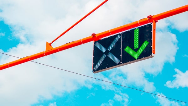 This green arrow on a lane use control signal means that: