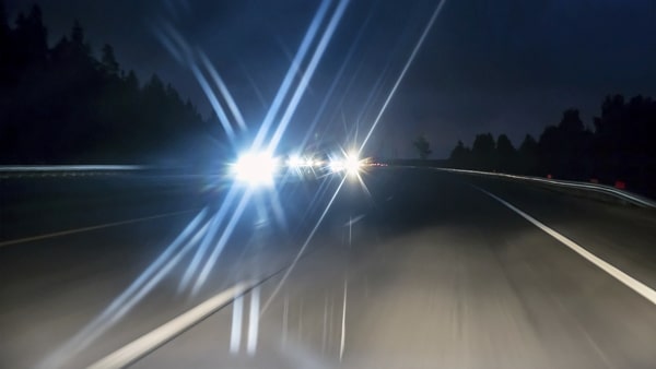 At night, if an oncoming vehicle fails to dim its high-beams, look: