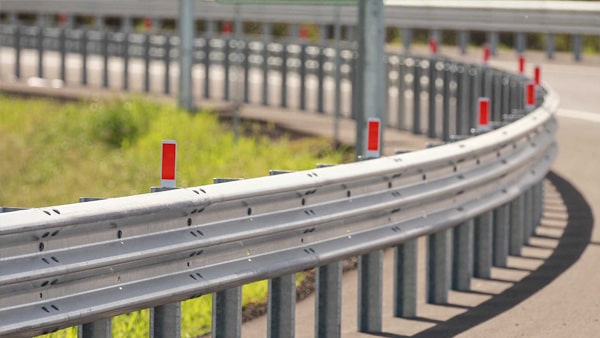 If a school bus stops to unload children on a divided highway with a dividing barrier, vehicles traveling in the opposite direction are: