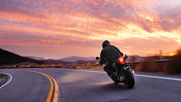If you are driving behind a motorcycle, you must: