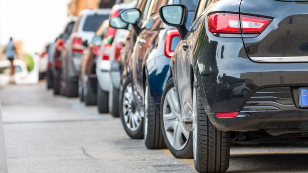 Before getting out of your parked car on the traffic side of the street, you should:
