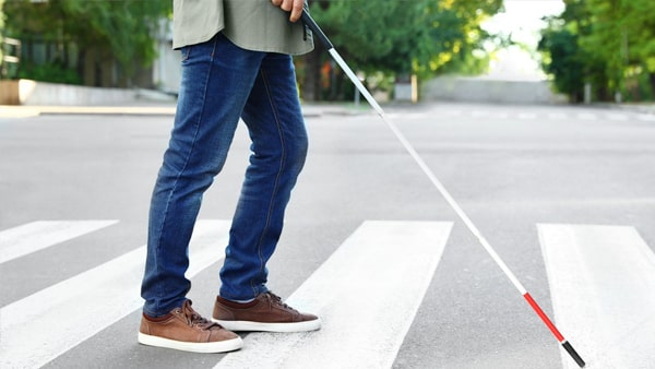 You need to use extra caution when driving near a pedestrian using a white cane because:
