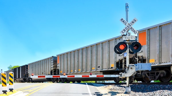 When may you legally drive around or under a railroad crossing gate?