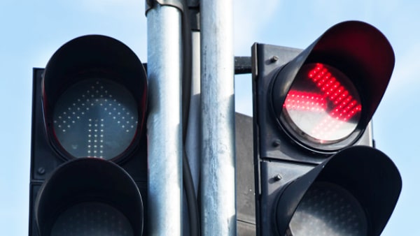 A red arrow pointing to the right on a traffic light means you may: