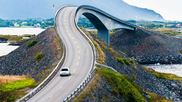 When you approach a sharp curve in the road, you should: