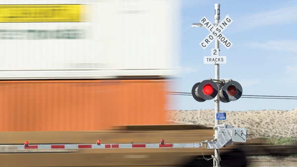 After a train has passed, you should: