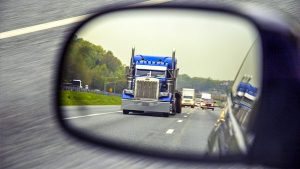 When a truck driver behind you wants to pass your vehicle, your speed should: